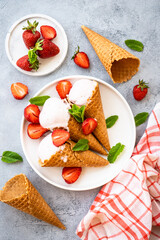 Homemade ice cream with fresh strawberries on stone table. Flat lay.