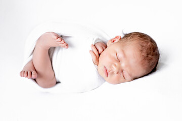 a newborn baby boy or girl in a diaper on a white background is sleeping sweetly, the birth of a baby, a happy family