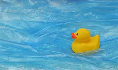 Pollution Plastic In Sea with Yellow Rubber Duck Toy and Plastic Waves - 612784265