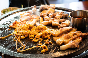Fresh and delicious iron pan-fried black pork meal in Jeju Korean characteristic restaurant.