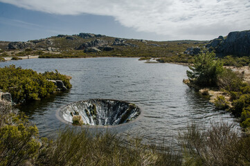 Behold the mesmerizing Covão dos Conchos, a lake with a captivating hole in Serra da Estrela,...
