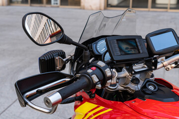 Rescue motorcycle steering wheel with instruments and navigation attached to it and a rear-view...