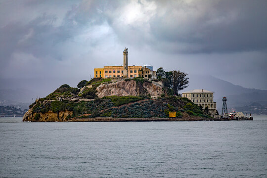 The federal prison of Alcatraz on its island in the middle of San Francisco Bay in California, USA under a cloudy sky. Prison of the United States of America of maximum security. Prison concept.