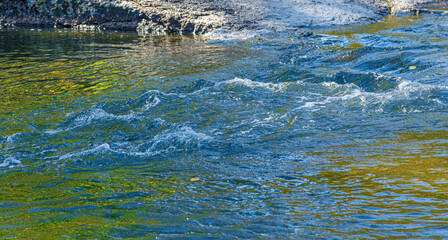 flow of water and spray from a stone