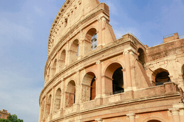 The Colosseum arena, known as Flavian Amphitheater, in a sunny day in Rome, external side view