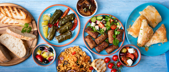 Various Greek dishes on a blue wooden background 