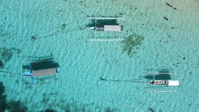 Fishing boats on anker in ocean on Bali island. Aerial view.