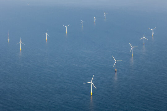 Aerial view of offshore wind farm with wind turbines on the North Sea