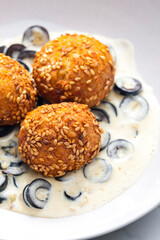 chickpeas balls with creamy black olives sauce