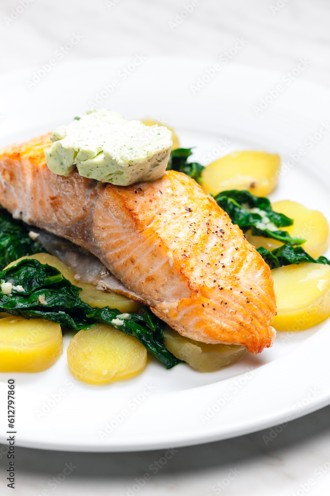 Wall mural baked salmon with spinach leaves and potatoes