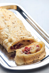 crispy pastry filled with smoked meat and sour cabbage