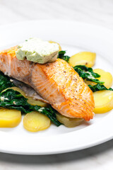 baked salmon with spinach leaves and potatoes