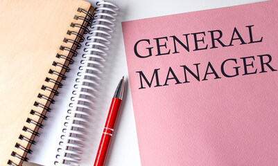 GENERAL MANAGER word on the pink paper with office tools on white background