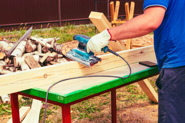 tree. natural wood in the shape of a rectangle. work piece. a man uses a tool to grind. sale.