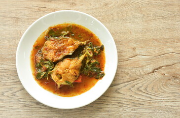spicy fried catfish with basil and chili in curry on plate