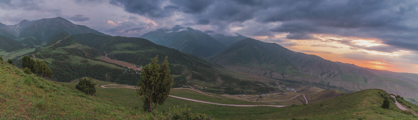 Fototapeta na wymiar Mountain panorama of sunset sky and mountain road.