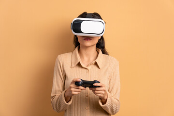 happy brazilian woman playing videogame with VR headset in beige background. virtual reality, gaming, leisure concept.