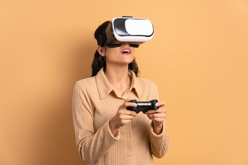 happy young woman playing videogame with VR headset in studio shot. virtual reality, gaming, leisure concept.