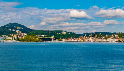 Panoramic view of Lucerne's waterfront from a boat on Lake Lucerne (Vierwaldstättersee). You can see the KKL building with the piers in front, the hotel Château Gütsch on the hill and the Old Town.