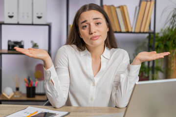 I dont know what to say. Confused business woman works on laptop at office workplace. Freelancer...