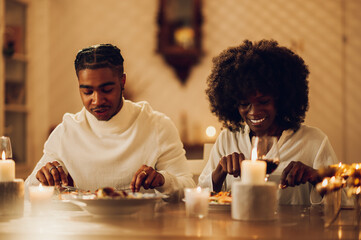 Fototapeta na wymiar African american couple having romantic dinner date at home
