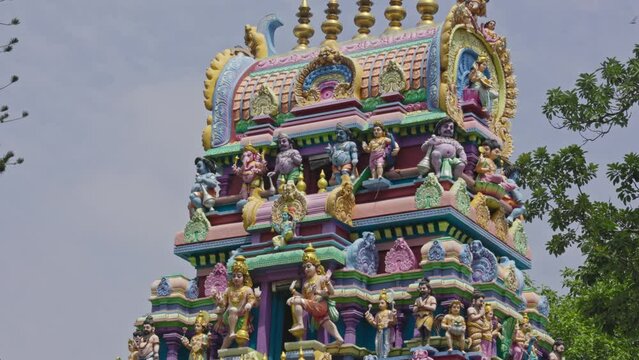 The Indian Hindu temple showcases a shikhara or tower adorned with god sculptures