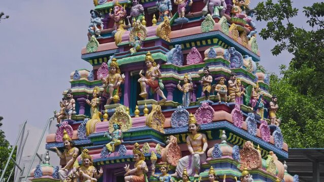 The Indian Hindu temple showcases a shikhara or tower adorned with god sculptures