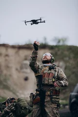 Tuinposter Portrait of Ukrainian military using a drone © dsheremeta