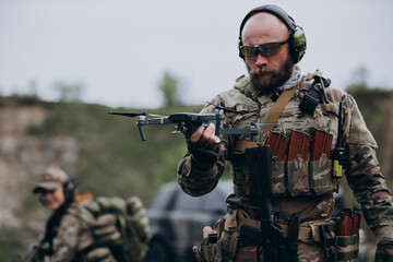 Fototapeta premium Portrait of Ukrainian military man holding a drone