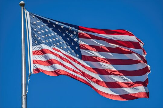 A powerful image of an American flag waving proudly in the wind against a clear blue sky. Generative AI