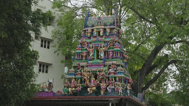 The Indian Hindu temple showcases a shikhara or tower adorned with god sculptures