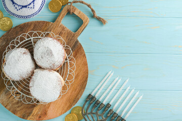 Happy Hanukkah. Hanukkah old Menorah against background of the Israeli flag with sunlight or bokeh on white wooden background. Religion image of jewish holiday Hanukkah background.