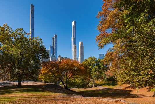 Central Park in Fall with view of supertall skyscrapers of Billionaires' Row. Midtown Manhattan, New York City