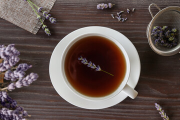 Cup with lavender tea and fresh lavender flowers. Top view, flat lay.