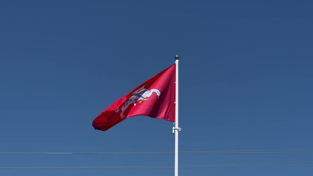 Coat of arms of Lithuania flag flying at blue background