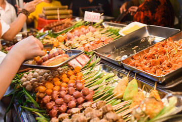 Many snacks and seafood in vietnamese night market in food festival