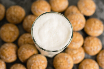 Flatlay, a delicious, refreshing summer drink in a glass, a milkshake made of milk and ice cream. Sweet foam cocktail close-up. Gingerbread on a dark table