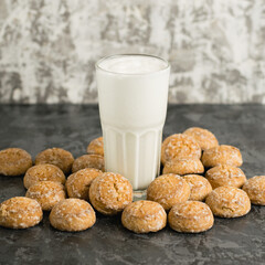 A delicious, refreshing summer drink, a milkshake made of milk and ice cream. Gingerbread on a dark table