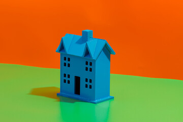 Blue plastic house on vibrant background