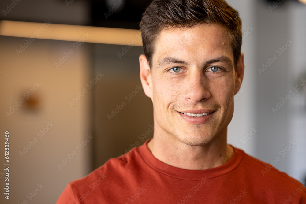 Wall mural portrait of happy caucasian casual businessman with blue eyes smiling in office