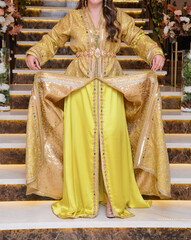 Moroccan woman wearing a yellow caftan