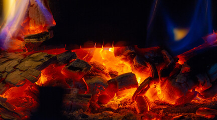 Fire in the fireplace. Fire is beneficial to most of our senses. We love the smell of smoke, the sight of shining light, the sound of crackling logs, the feeling of warmth on our skin. - obrazy, fototapety, plakaty