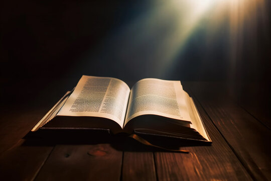 Open Bible with a light coming from above on a wooden desk Image ai generate
