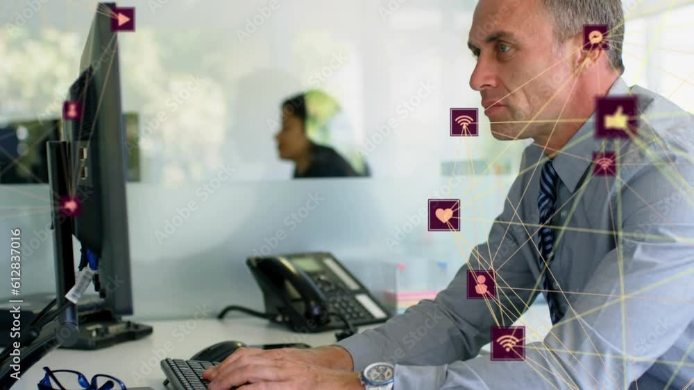 Poster animation of globes of digital icons spinning against caucasian businessman using computer at office