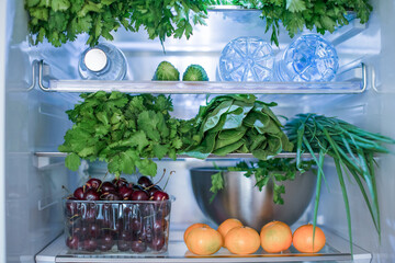 Open fridge full of fresh fruits and vegetables, vegetarian food healthy food background, greenery, organic nutrition, health care, dieting concept.