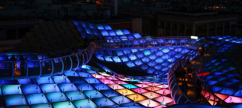 Metropol Parasol / Setas in Seville illuminated and coloured at the night, Andalucia, Spain