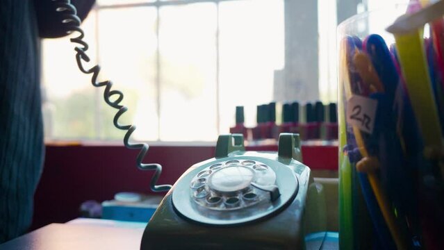 4K footage of picking up incoming call on analogue rotary telephone in the store stock video.