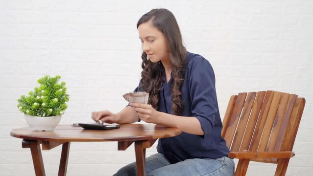 Happy Indian businesswoman couting money