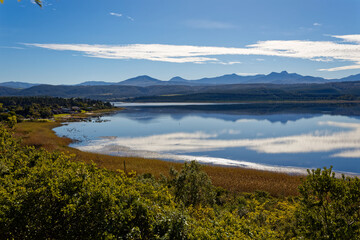 Late afternoon with cloud reflections over a large lake with reeds and waterfowl near Knysna, South Africa.