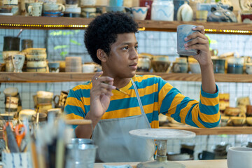Fototapeta premium The art of pottery, African american boys finding joy and fulfillment in the ancient craft of clay molding.